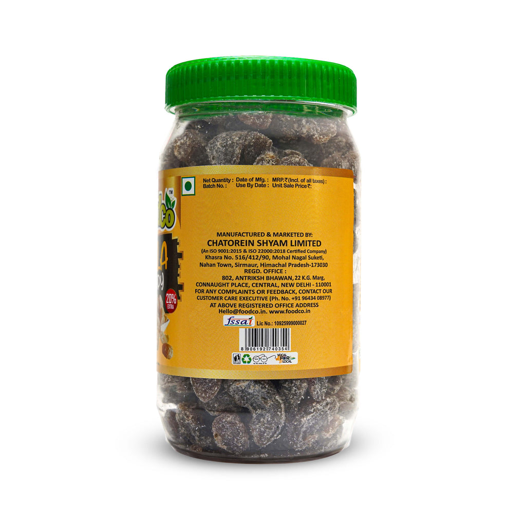 Jar of dried fruits with a green lid on a white background