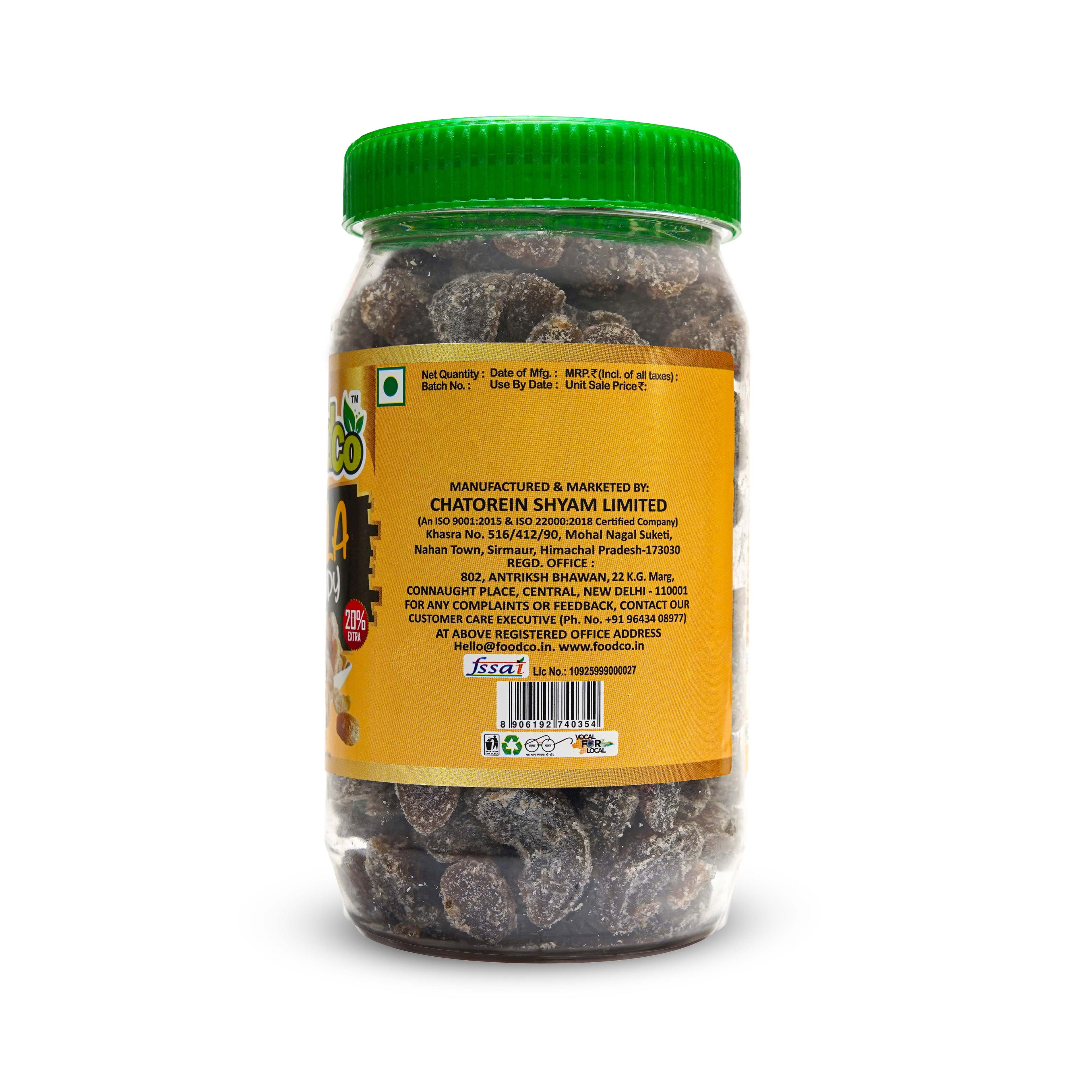 Jar of dried fruits with a green lid on a white background