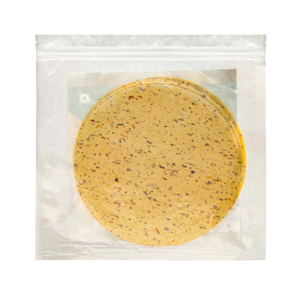 Round yellow snack in a clear plastic package on a white background