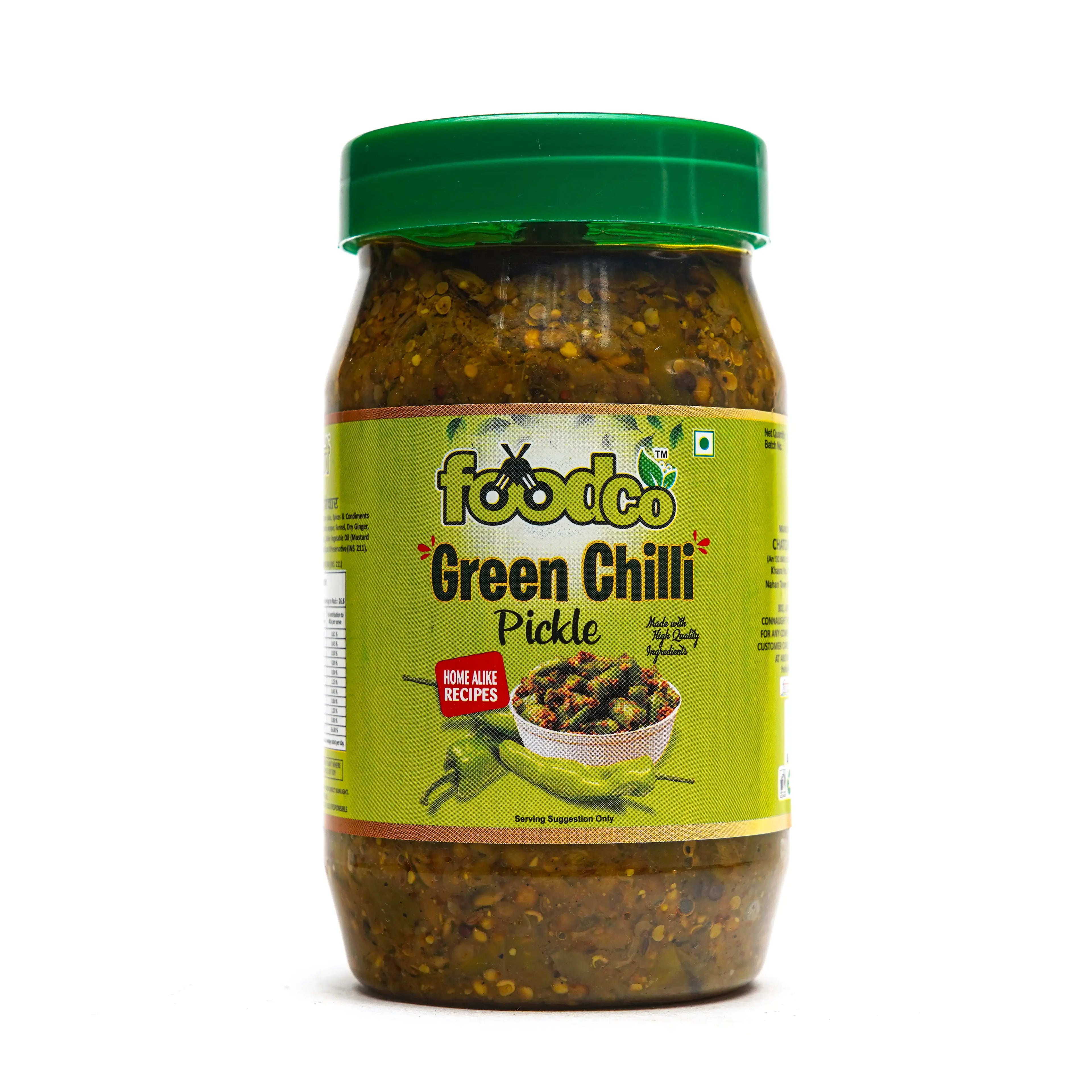 Jar of green chili pickle with a green lid on a white background