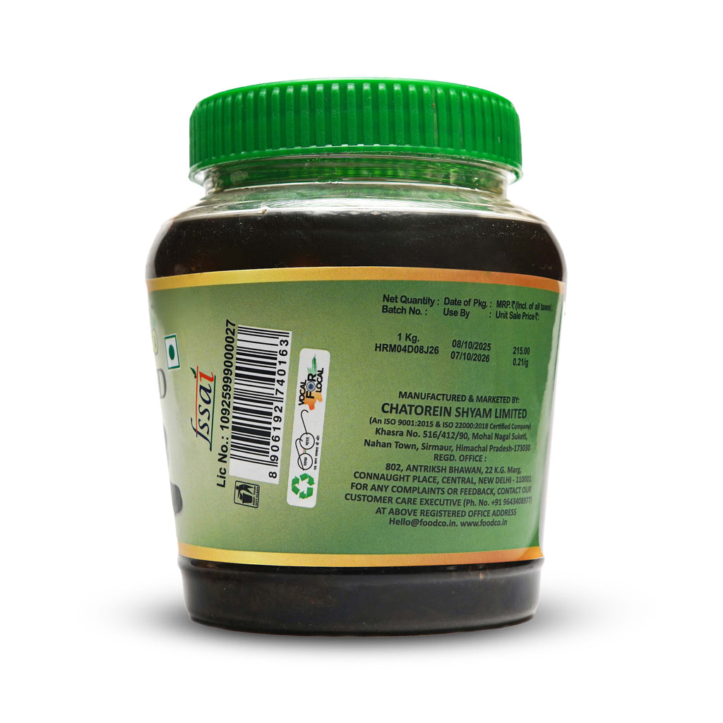 Back view of a green-lidded jar with label on a white background