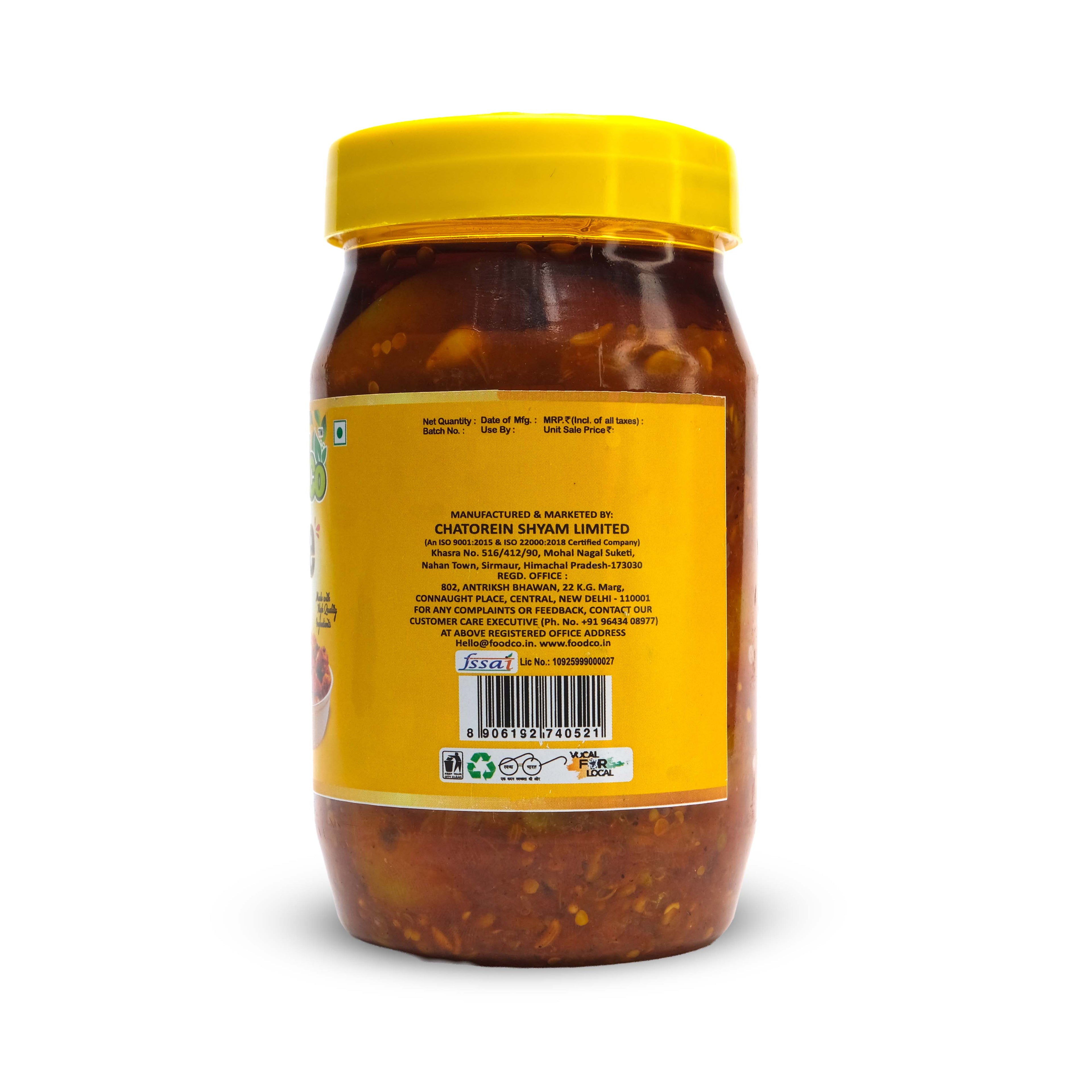 Jar of spicy sauce with a yellow lid and label on a white background