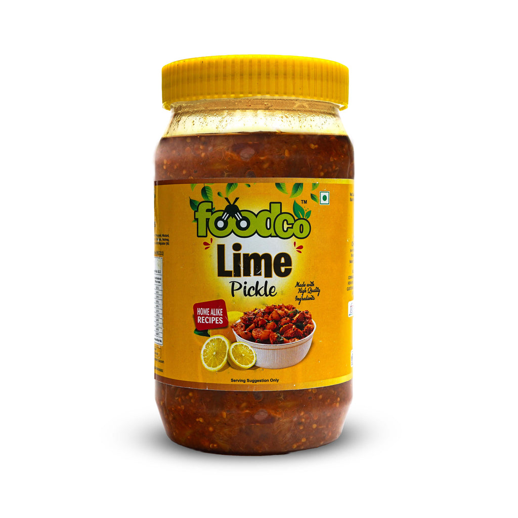 Jar of lime pickle with yellow lid and label on a white background