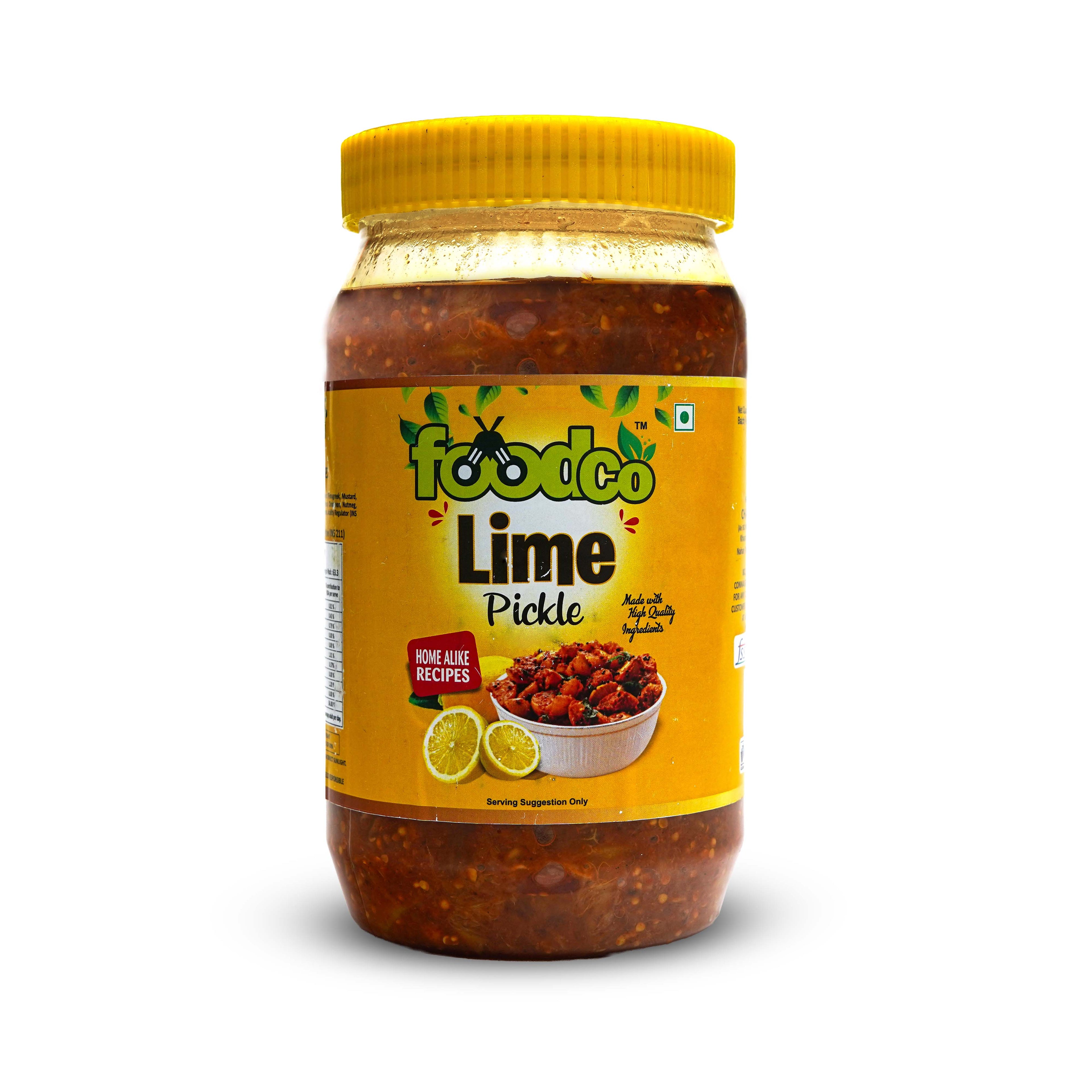 Jar of lime pickle with yellow lid and label on a white background
