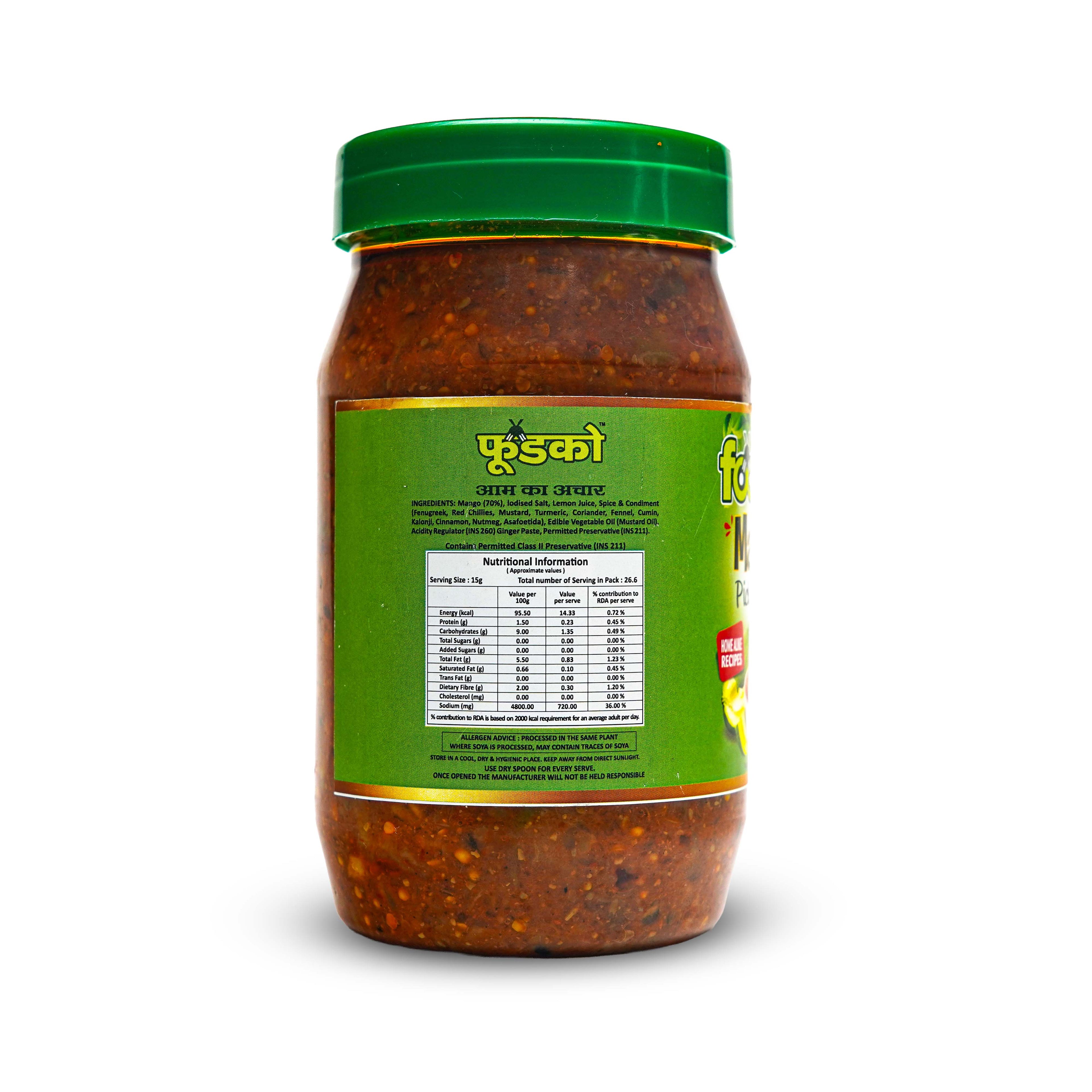 Jar of red chili paste with green label and lid on a white background