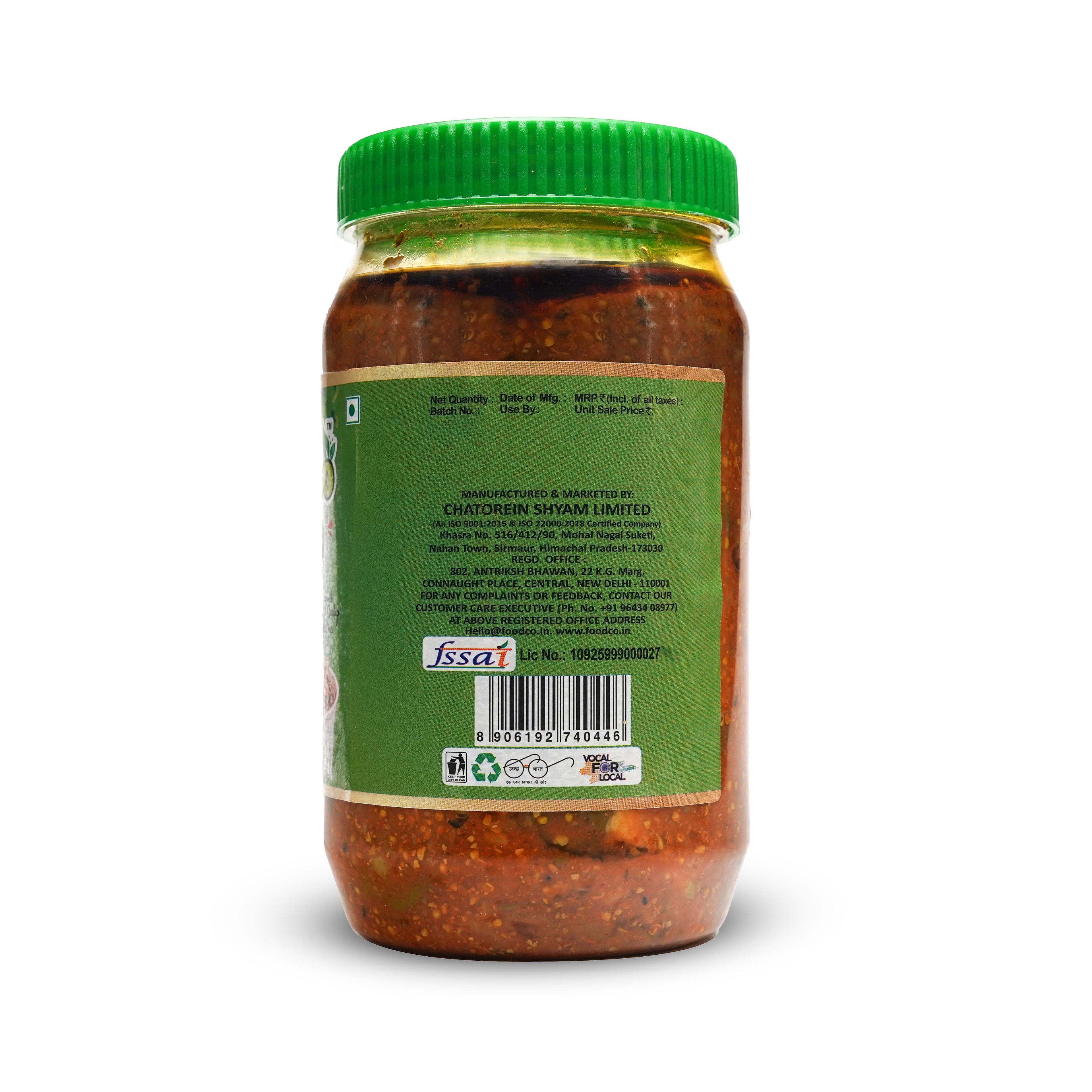 Jar of red chili paste with green lid and label on a white background