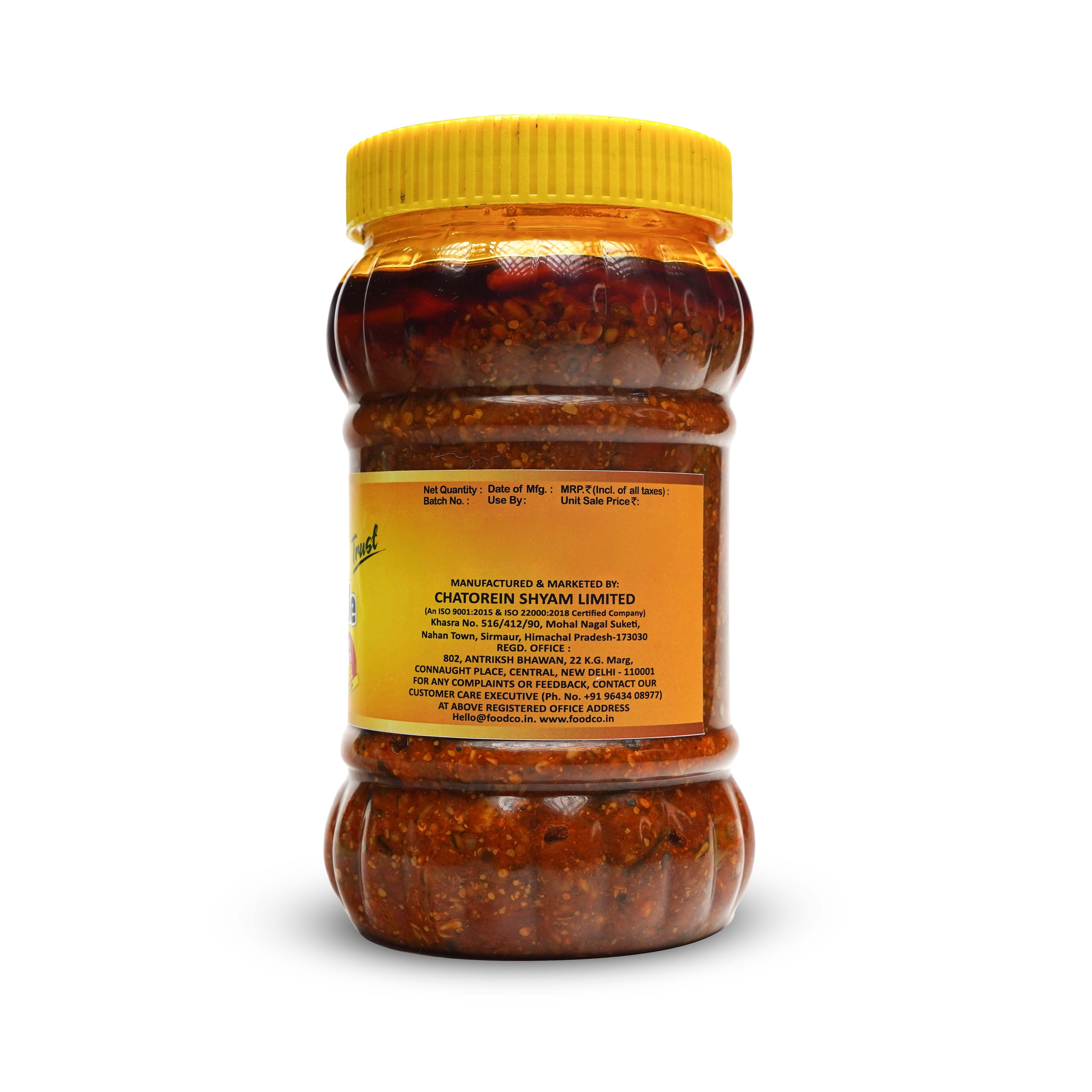 Jar of red chili paste with a yellow lid on a white background