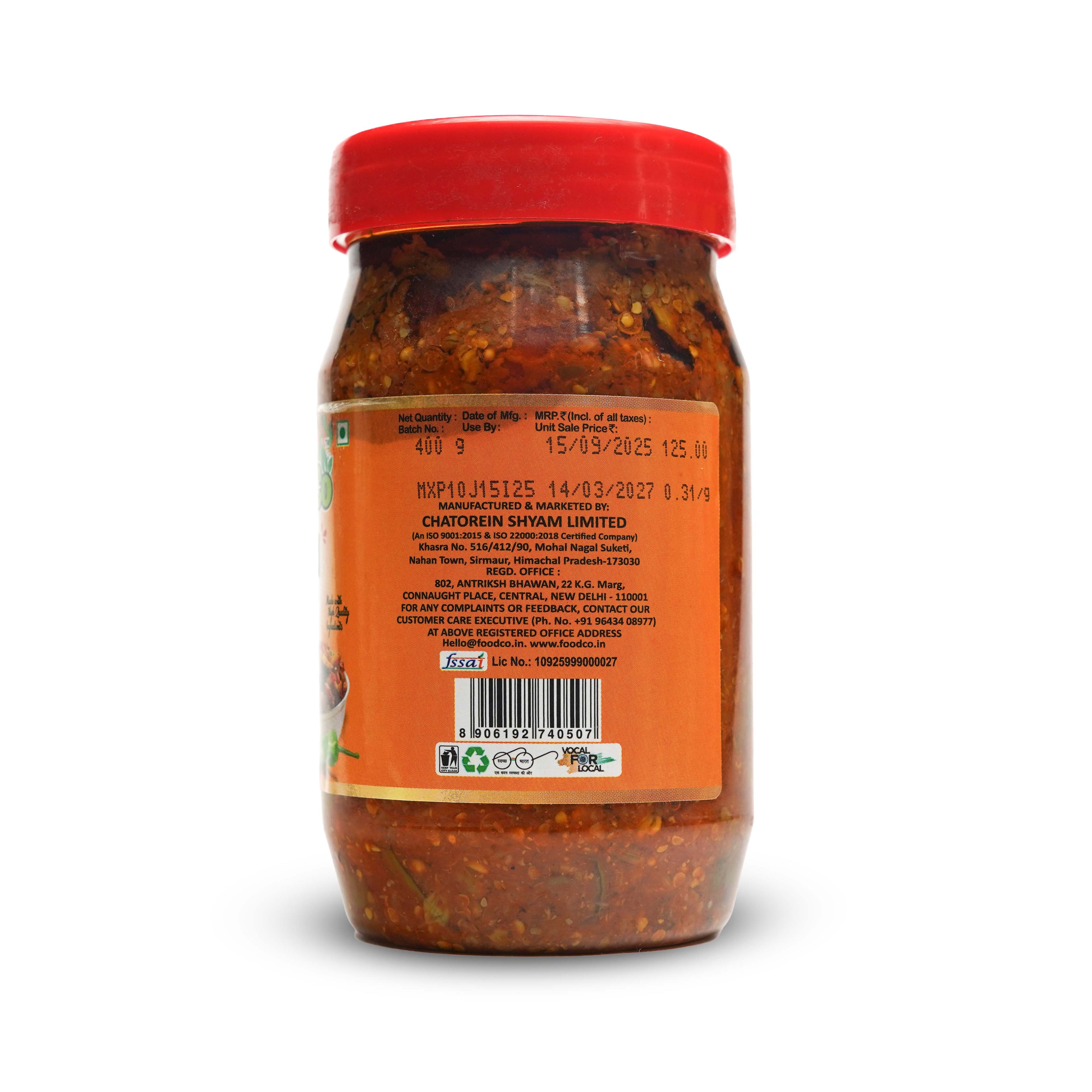 Jar of red chili paste with a red lid on a white background