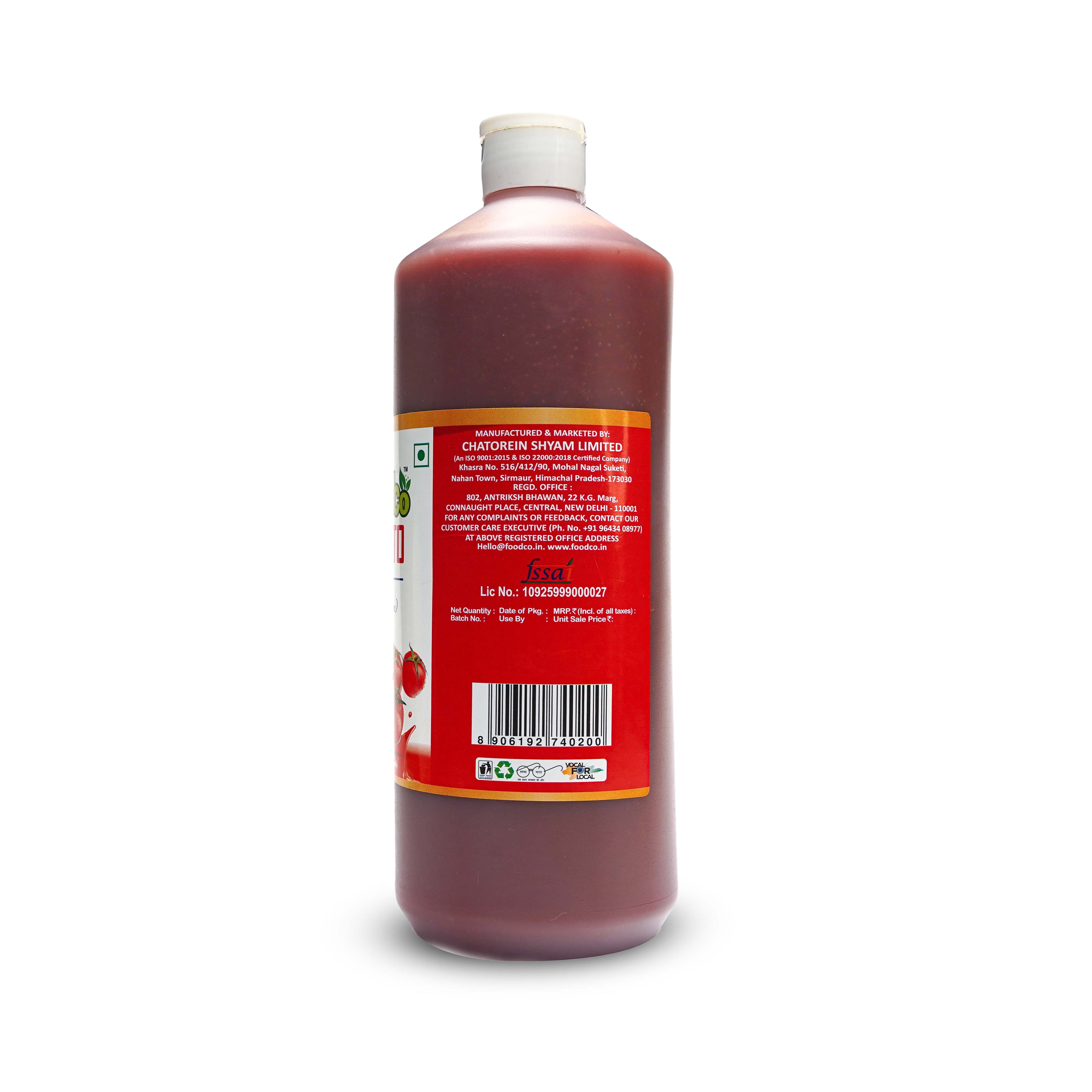 Bottle of red liquid with a label on a white background