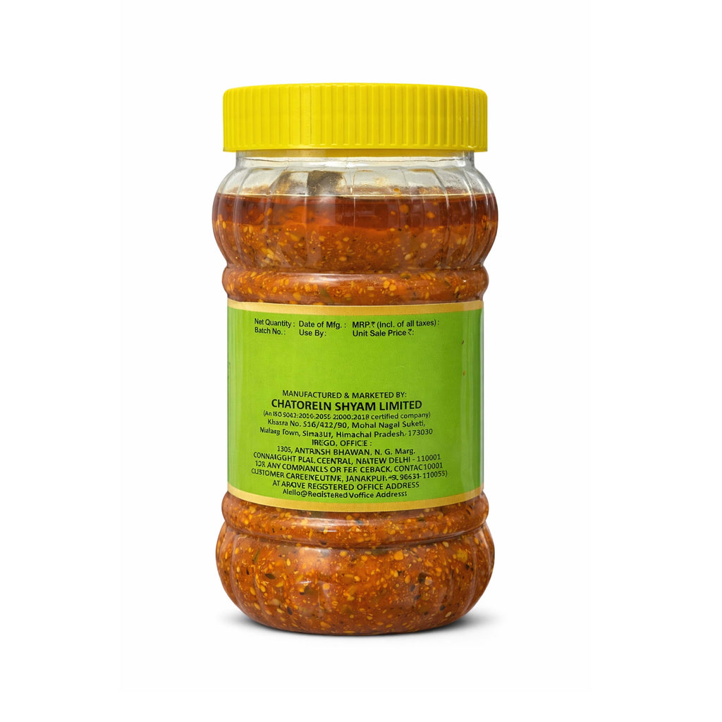 Jar of red chili paste with a yellow lid on a white background